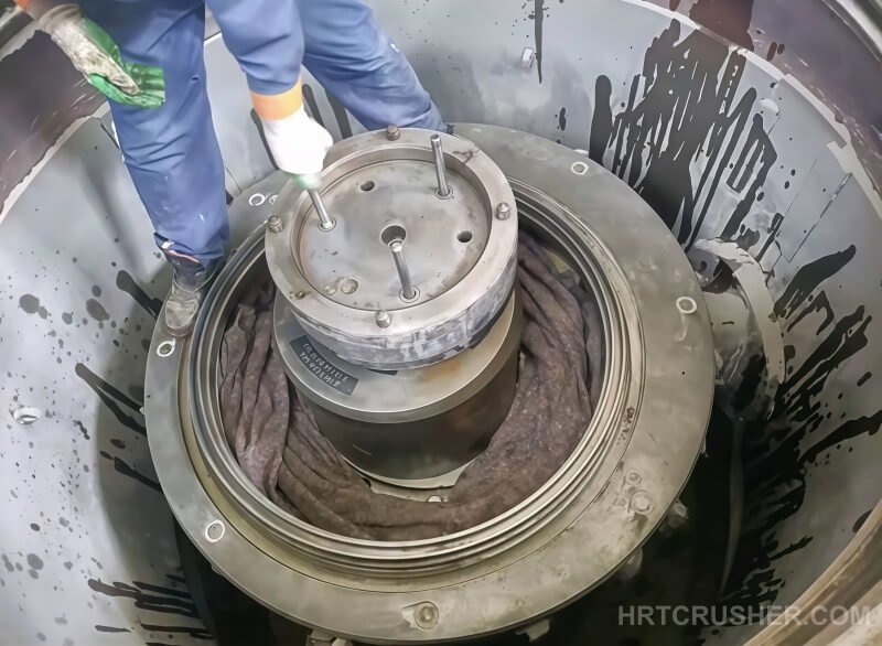 Technician installing and torquing thrust plate bolts during HP500 maintenance